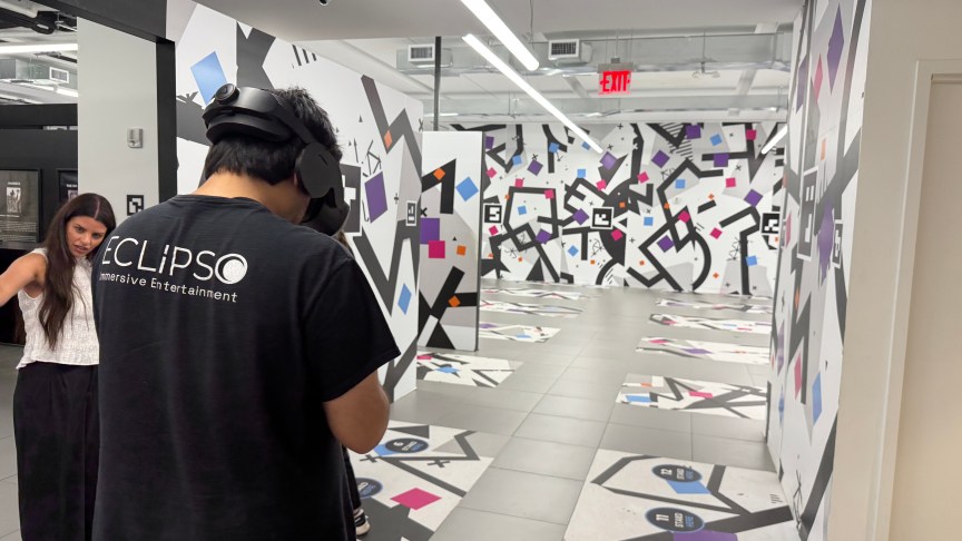 person wearing a VR headset moving through a maze