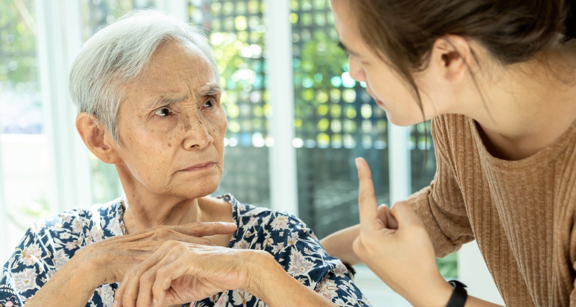 Asian senior woman is confused because she can not remember the face of their family or forget her daughter - memory loss in elderly people