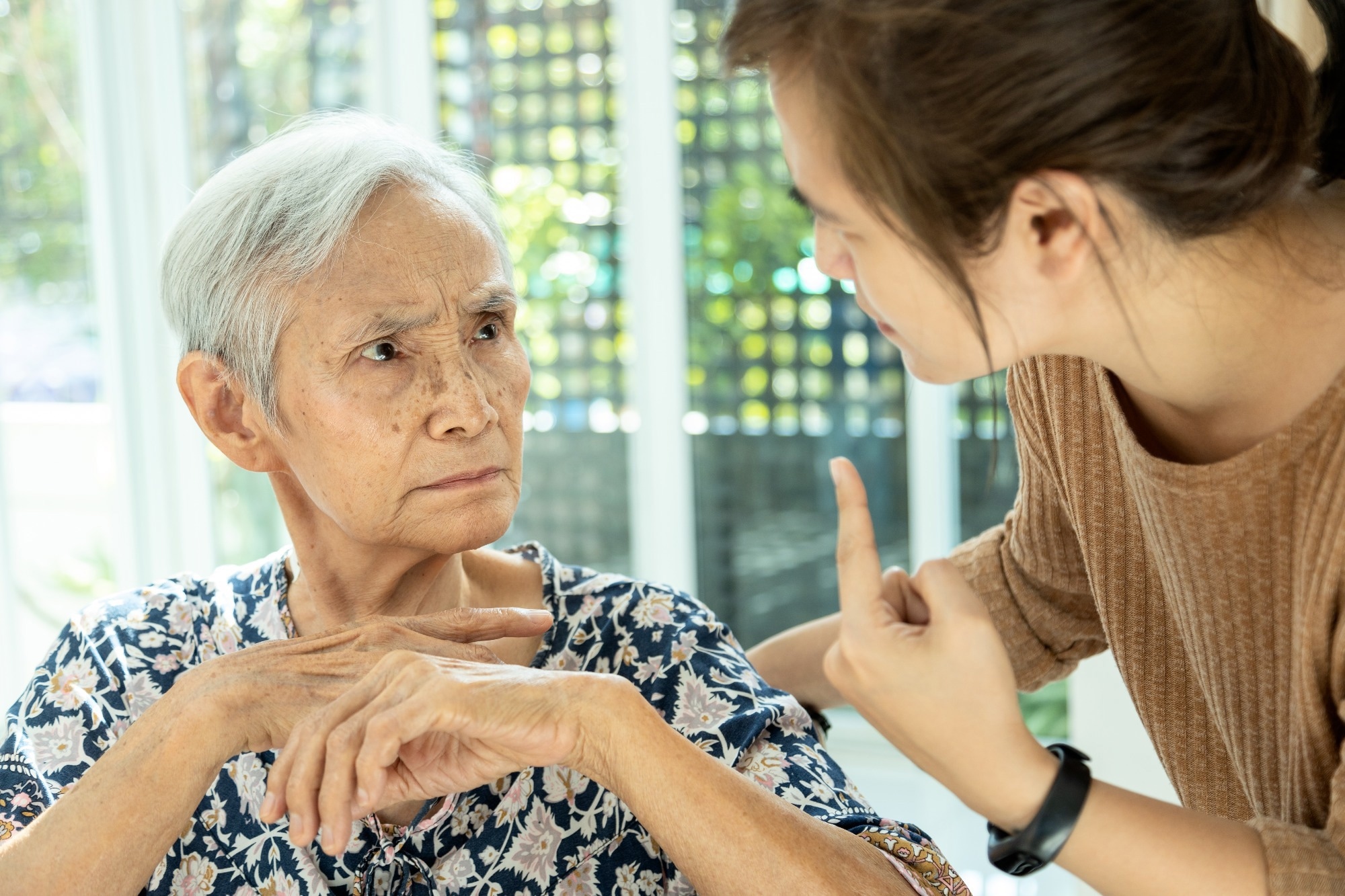 Asian senior woman is confused because she can not remember the face of their family or forget her daughter - memory loss in elderly people