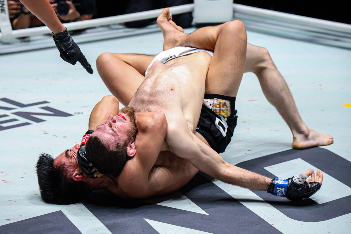 Joshua Pacio applies a rear-naked choke on Mansur Malachiev at The Inner Circle