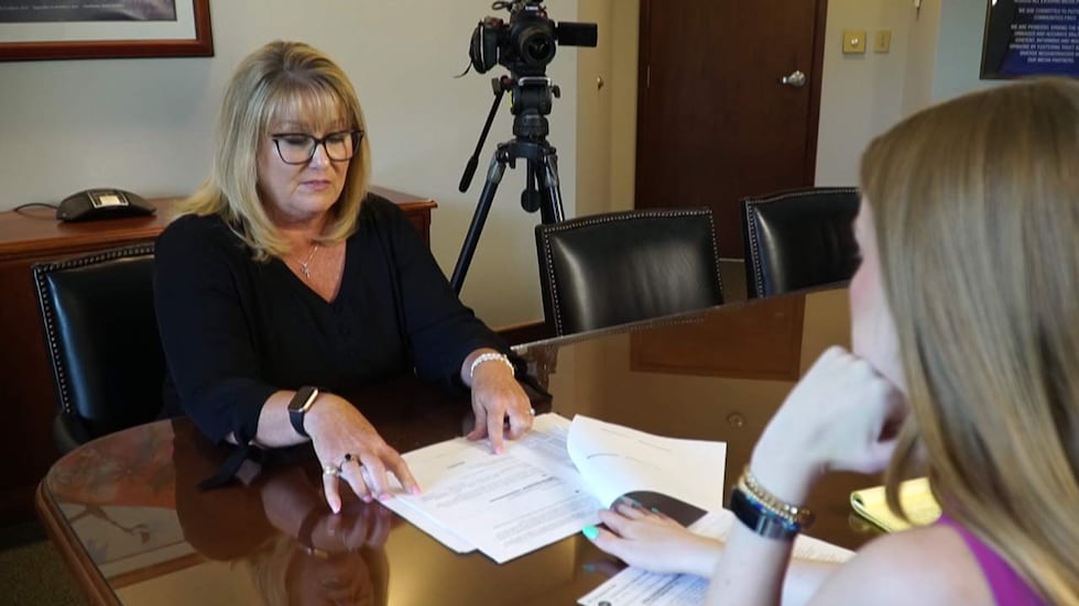 Coastal Pediatric Associates' former human resources director, Donna Howard, shows pay stubs...