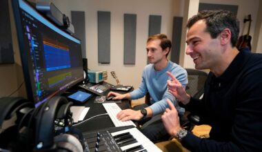 Cambridge music AI startup Suno raised $400 million in the second quarter. Chief executive Mikey Shulman, right, and research scientist Christian Steinmetz, collaborate on creating a song.