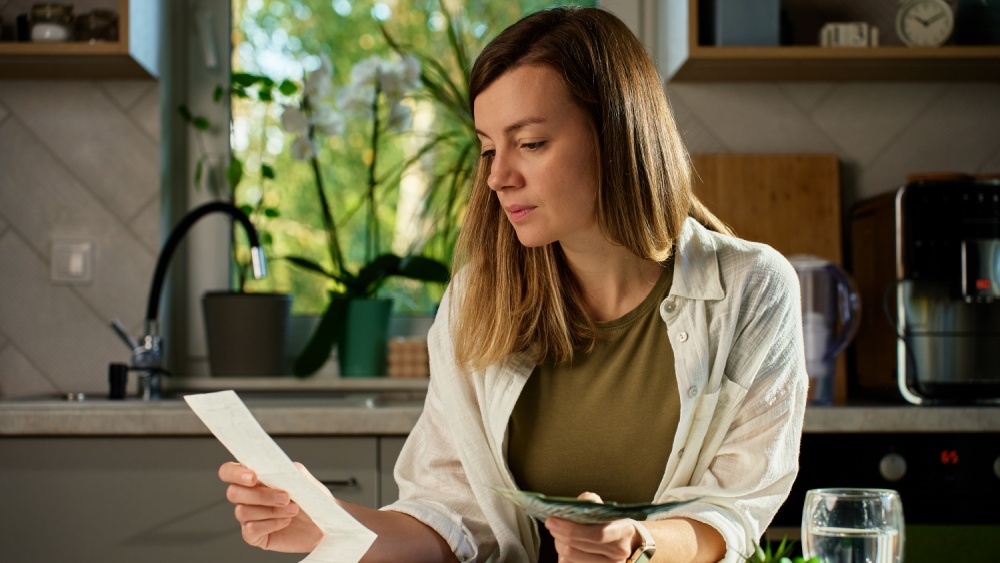 Woman looking at a receipt.