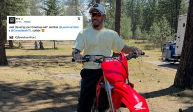 Lewis Hamilton wearing a Montreal Canadiens hat on a motorcycle in the woods.