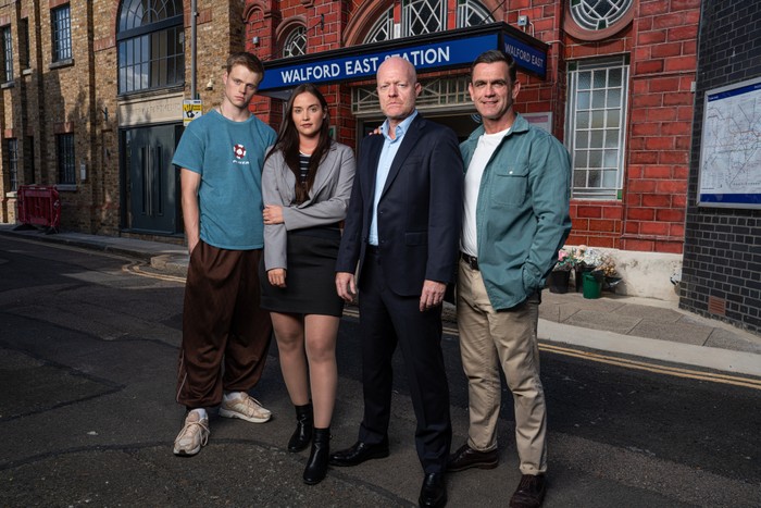 Pierre Moullier, Jacqueline Jossa, Jake Wood and Scott Maslen in character, stood in front of a tube station looking ahead.