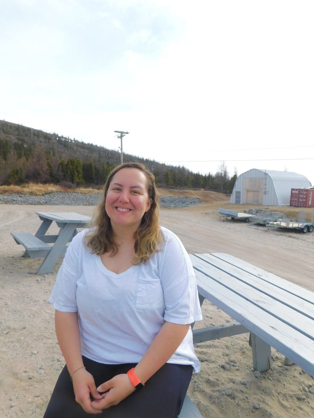 Nain, Labrador, resident Michelle Saunders poses for a photo while sitting at a picnic table.