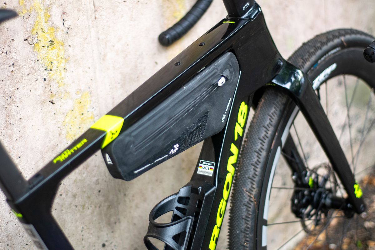 An Argon 18 Anti Matter gravel bike leaning against a concrete wall.
