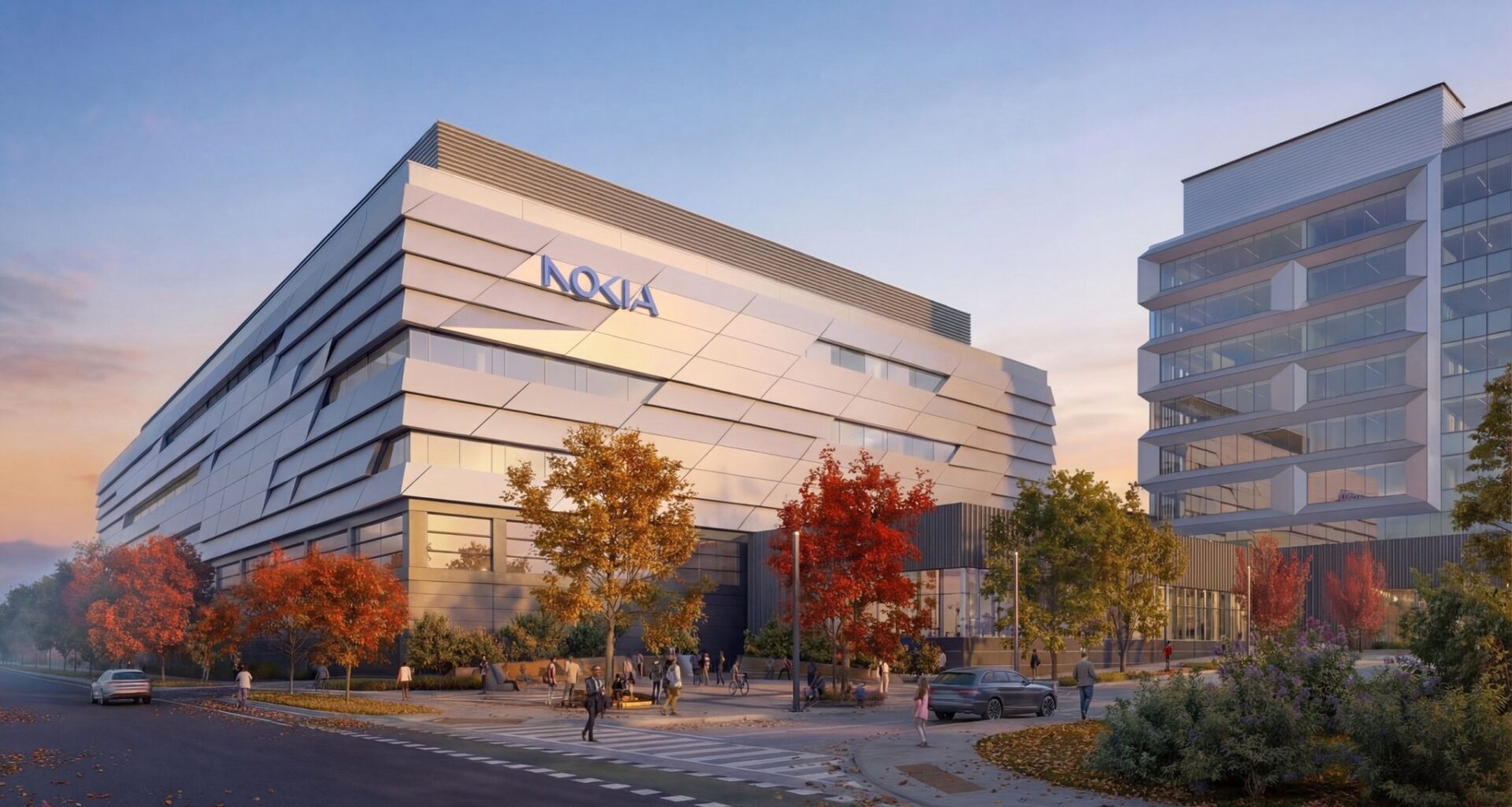 Modern building with Nokia logo, featuring geometric design and large windows, surrounded by autumn trees at sunset, evoking a calm, innovative atmosphere.