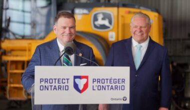 Two men stand behind a lectern that says "Protect Ontario" on it in English and French.