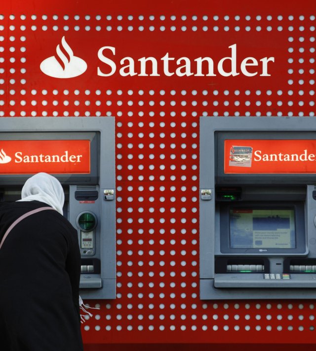 A customer uses an automated teller machine (ATM) at a Banco Santander SA bank branch in London, U.K., on Friday, Oct. 22, 2021. The leaders of Europe's top banks agree they have a lot riding on the recent surge in consumer prices. Photographer: Luke MacGregor/Bloomberg via Getty Images