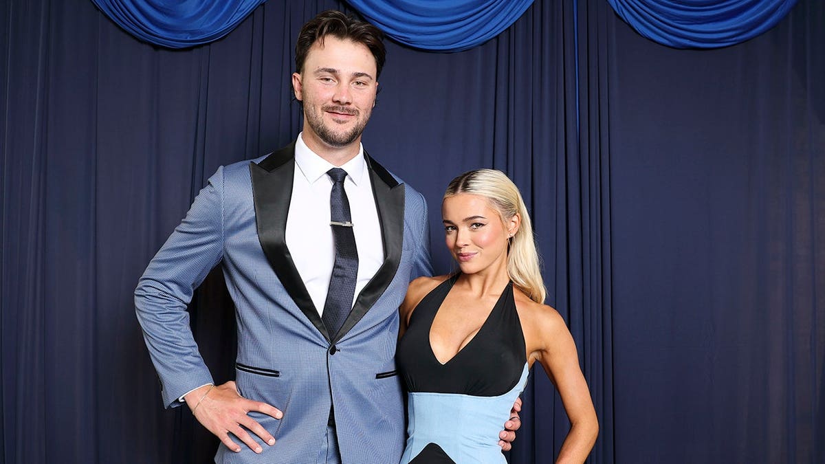 Paul Skenes poses with Olivia Dunne at a red carpet photoshoot in Philadelphia.