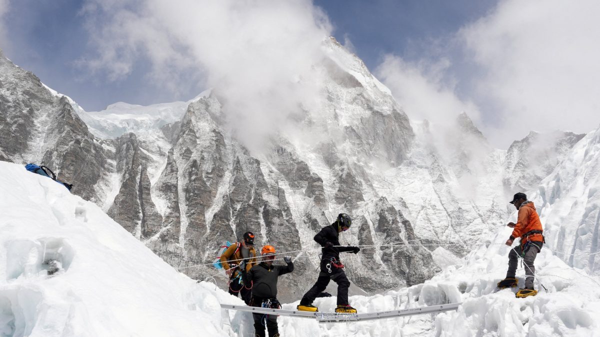 FILE PHOTO: Mountaineers practice walking on a ladder during a training session at Everest base camp, Nepal April 15, 2025. REUTERS/Purnima Shrestha/File Photo