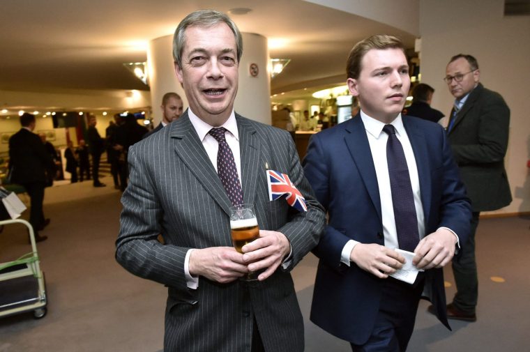 Britain's Brexit Party leader Nigel Farage, accompanied by George Cottrell (2R), drinks a beer on the sidelines of a European Parliament plenary session in Brussels on January 29, 2020, as Brexit Day is to be set in stone when the European Parliament casts a vote ratifying the terms of Britain's divorce deal from the EU. (Photo by JOHN THYS / AFP via Getty Images)