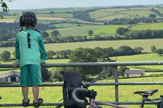 **NOTE TO EDITORS: Please retain social media handle and link to crowdfunder. Ro does not wish to name her kids, have her children???s faces visible, or list her husband???s name or job.** WORDS BYLINE: Sarah Ingram As many mums prepare for six weeks or more of juggling their children's various needs over the summer holidays, one woman has taken parenting on the road by strapping her two young sons onto a bike for an epic 1,000-mile ride from Land???s End to John O'Groats. Ro Marshall has packed her panniers and is pedalling with her one- and four-year-old on the monster journey, stopping at as many play parks as she can find along the way. The boys, who she has decided not to name, swap between the bike seat and the trailer. The ride will consist of approximately 39 stages of between 15 and 36 miles, which she expects to complete in around seven weeks. Her husband will be waiting for her at the finish, ready to take over with the boys and allow her to enjoy her first solo bath in two months. The 36-year-old content creator from Barnstaple said: ???We are living day by day, and though my husband is working away, he is a fantastic help in figuring out where we are going to sleep each night and where we will stop the next day.??? Ro set off in June and is now three weeks into her trip, more than halfway to her destination. Sometimes she carries all their clothes, waterproofs, electronics, food and drink. At other times, friends along the route drive their belongings to the next Airbnb, hotel or family home. She is sticking to quiet roads and scenic routes, allowing her to chat with her sons as they travel and giving them the chance to see landmarks away from the busiest roads. "But that brings its own challenges because it's normally back roads that are little used, gravelly and have grass growing up the middle. But it's been really beautiful,??? says Ro. "I'm buying a pint of milk each night so they can drink it straight from the bottle. This trip isn't going to win me any awards for diet of the year. I???m being quite lax. But we always have a cucumber and a punnet of strawberries with us." It's been a challenging journey, but an enjoyable one, Ro says. During hot weather she sets off very early to avoid the worst of the sun and takes regular breaks in the shade. On the steepest hills, her four-year-old gets off and walks alongside the bike. "Maybe we'll pretend to race each other. Maybe we'll put on some music and he'll dance alongside me. We're just having a lot of fun,??? says Ro. "My husband knows where we are all the time and he's really proud of us. He sends videos for the boys to watch in the mornings and is always in touch through voice notes and FaceTime. He loves hearing about our day and is super supportive." Each leg takes about eight hours, with Ro cycling in roughly two-hour chunks before taking a break. But even when she stops, there is little chance for Ro to rest. She is still expected to play pirates, push swings, scale climbing frames, feed the boys and settle the occasional squabble during breaks. "But that's being a mum wherever you are. Yes, I get tired, but I've got to carry on and get us to the next place. Then I have to get ready to go again the next morning, getting up at six to prepare the bike and make the boys' breakfast before we leave at eight." For Ro, the challenge is about doing something different and making the most of her eldest son before he starts school in September. With her husband working away all summer, it also felt like the perfect opportunity for an adventure. "My whole motto in motherhood is that you can do anything you want to do. I created my Instagram account @???britishadventuremum three years ago to help other women have the confidence to break free from society's narrative that life ends when you have kids,??? says Ro. "I've had a great time in motherhood because I've leaned into the idea that if there's something I want to do, I ask myself how I can make it work for the kids." She only books accommodation the night before, allowing her to slow the pace if needed. Once she arrives at her destination each afternoon, she secures the bike, gets the boys showered, finds another play park, washes clothes in the bathroom sink, feeds the boys, uploads content to and plans the following day's route. It???s full on, and there have been flat tyres, punctures and plenty of frustrations along the way, but she says the journey has been an incredible educational experience and provided a wonderful way for them to connect. "When I'm on the bike, my four-year-old will be telling me things and I'm really listening because I'm not distracted by my phone, the washing up or the laundry,??? says Ro. ???He???s been really outgoing talking to people we meet along the way about our adventure, and it's been great seeing how mature and helpful he's been." Ro says the journey has been made up of countless micro-adventures and memorable moments, including cycling through Cheddar Gorge and crossing the Severn Bridge. And she is also enjoying connecting with mothers around the world who message her online to say she has inspired them. "To hear you're having a positive impact on another family's life is amazing. Little old me from Bideford, North Devon, has created this page that's having an impact on people all over the world. It's a great feeling." So far, Ro has raised more than ??13,000 for the PANDAS Foundation. "It's a great organisation which supports families affected by perinatal mental illness. The charity provides services including a helpline, text and WhatsApp support, face-to-face groups and peer support from pregnancy through to the postnatal period. ???It's a brilliant charity and I'm really grateful for every donation I receive.??? Featuring: Ro's son, experiencing rural Britain When: 14 Jul 2026 Credit: Cover Images **All usages and enquiries, please contact info@cover-images.com - +44 (0)20 3397 3000EDITORIAL USE ONLY. MATERIALS ONLY TO BE USED IN CONJUNCTION WITH EDITORIAL STORY. THE USE OF THESE MATERIALS FOR ADVERTISING, MARKETING OR ANY OTHER COMMERCIAL PURPOSE IS STRICTLY PROHIBITED. MATERIAL COPYRIGHT REMAINS WITH STATED PHOTOGRAPHER AND/OR SUPPLIER.**