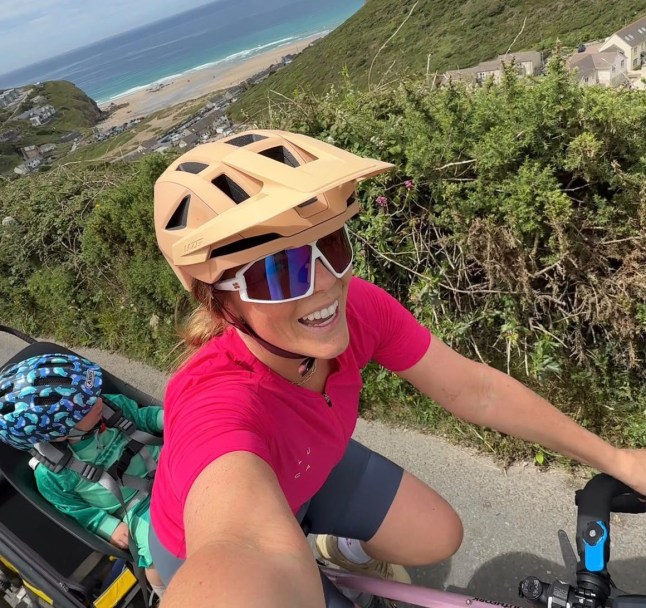 **NOTE TO EDITORS: Please retain social media handle and link to crowdfunder. Ro does not wish to name her kids, have her children???s faces visible, or list her husband???s name or job.** WORDS BYLINE: Sarah Ingram As many mums prepare for six weeks or more of juggling their children's various needs over the summer holidays, one woman has taken parenting on the road by strapping her two young sons onto a bike for an epic 1,000-mile ride from Land???s End to John O'Groats. Ro Marshall has packed her panniers and is pedalling with her one- and four-year-old on the monster journey, stopping at as many play parks as she can find along the way. The boys, who she has decided not to name, swap between the bike seat and the trailer. The ride will consist of approximately 39 stages of between 15 and 36 miles, which she expects to complete in around seven weeks. Her husband will be waiting for her at the finish, ready to take over with the boys and allow her to enjoy her first solo bath in two months. The 36-year-old content creator from Barnstaple said: ???We are living day by day, and though my husband is working away, he is a fantastic help in figuring out where we are going to sleep each night and where we will stop the next day.??? Ro set off in June and is now three weeks into her trip, more than halfway to her destination. Sometimes she carries all their clothes, waterproofs, electronics, food and drink. At other times, friends along the route drive their belongings to the next Airbnb, hotel or family home. She is sticking to quiet roads and scenic routes, allowing her to chat with her sons as they travel and giving them the chance to see landmarks away from the busiest roads. "But that brings its own challenges because it's normally back roads that are little used, gravelly and have grass growing up the middle. But it's been really beautiful,??? says Ro. "I'm buying a pint of milk each night so they can drink it straight from the bottle. This trip isn't going to win me any awards for diet of the year. I???m being quite lax. But we always have a cucumber and a punnet of strawberries with us." It's been a challenging journey, but an enjoyable one, Ro says. During hot weather she sets off very early to avoid the worst of the sun and takes regular breaks in the shade. On the steepest hills, her four-year-old gets off and walks alongside the bike. "Maybe we'll pretend to race each other. Maybe we'll put on some music and he'll dance alongside me. We're just having a lot of fun,??? says Ro. "My husband knows where we are all the time and he's really proud of us. He sends videos for the boys to watch in the mornings and is always in touch through voice notes and FaceTime. He loves hearing about our day and is super supportive." Each leg takes about eight hours, with Ro cycling in roughly two-hour chunks before taking a break. But even when she stops, there is little chance for Ro to rest. She is still expected to play pirates, push swings, scale climbing frames, feed the boys and settle the occasional squabble during breaks. "But that's being a mum wherever you are. Yes, I get tired, but I've got to carry on and get us to the next place. Then I have to get ready to go again the next morning, getting up at six to prepare the bike and make the boys' breakfast before we leave at eight." For Ro, the challenge is about doing something different and making the most of her eldest son before he starts school in September. With her husband working away all summer, it also felt like the perfect opportunity for an adventure. "My whole motto in motherhood is that you can do anything you want to do. I created my Instagram account @???britishadventuremum three years ago to help other women have the confidence to break free from society's narrative that life ends when you have kids,??? says Ro. "I've had a great time in motherhood because I've leaned into the idea that if there's something I want to do, I ask myself how I can make it work for the kids." She only books accommodation the night before, allowing her to slow the pace if needed. Once she arrives at her destination each afternoon, she secures the bike, gets the boys showered, finds another play park, washes clothes in the bathroom sink, feeds the boys, uploads content to and plans the following day's route. It???s full on, and there have been flat tyres, punctures and plenty of frustrations along the way, but she says the journey has been an incredible educational experience and provided a wonderful way for them to connect. "When I'm on the bike, my four-year-old will be telling me things and I'm really listening because I'm not distracted by my phone, the washing up or the laundry,??? says Ro. ???He???s been really outgoing talking to people we meet along the way about our adventure, and it's been great seeing how mature and helpful he's been." Ro says the journey has been made up of countless micro-adventures and memorable moments, including cycling through Cheddar Gorge and crossing the Severn Bridge. And she is also enjoying connecting with mothers around the world who message her online to say she has inspired them. "To hear you're having a positive impact on another family's life is amazing. Little old me from Bideford, North Devon, has created this page that's having an impact on people all over the world. It's a great feeling." So far, Ro has raised more than ??13,000 for the PANDAS Foundation. "It's a great organisation which supports families affected by perinatal mental illness. The charity provides services including a helpline, text and WhatsApp support, face-to-face groups and peer support from pregnancy through to the postnatal period. ???It's a brilliant charity and I'm really grateful for every donation I receive.??? Featuring: The baby and toddler alternate between seat and trailer When: 14 Jul 2026 Credit: Cover Images **All usages and enquiries, please contact info@cover-images.com - +44 (0)20 3397 3000EDITORIAL USE ONLY. MATERIALS ONLY TO BE USED IN CONJUNCTION WITH EDITORIAL STORY. THE USE OF THESE MATERIALS FOR ADVERTISING, MARKETING OR ANY OTHER COMMERCIAL PURPOSE IS STRICTLY PROHIBITED. MATERIAL COPYRIGHT REMAINS WITH STATED PHOTOGRAPHER AND/OR SUPPLIER.**