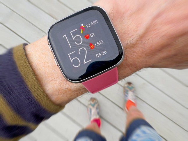 Fitness watch showing calories and step count.