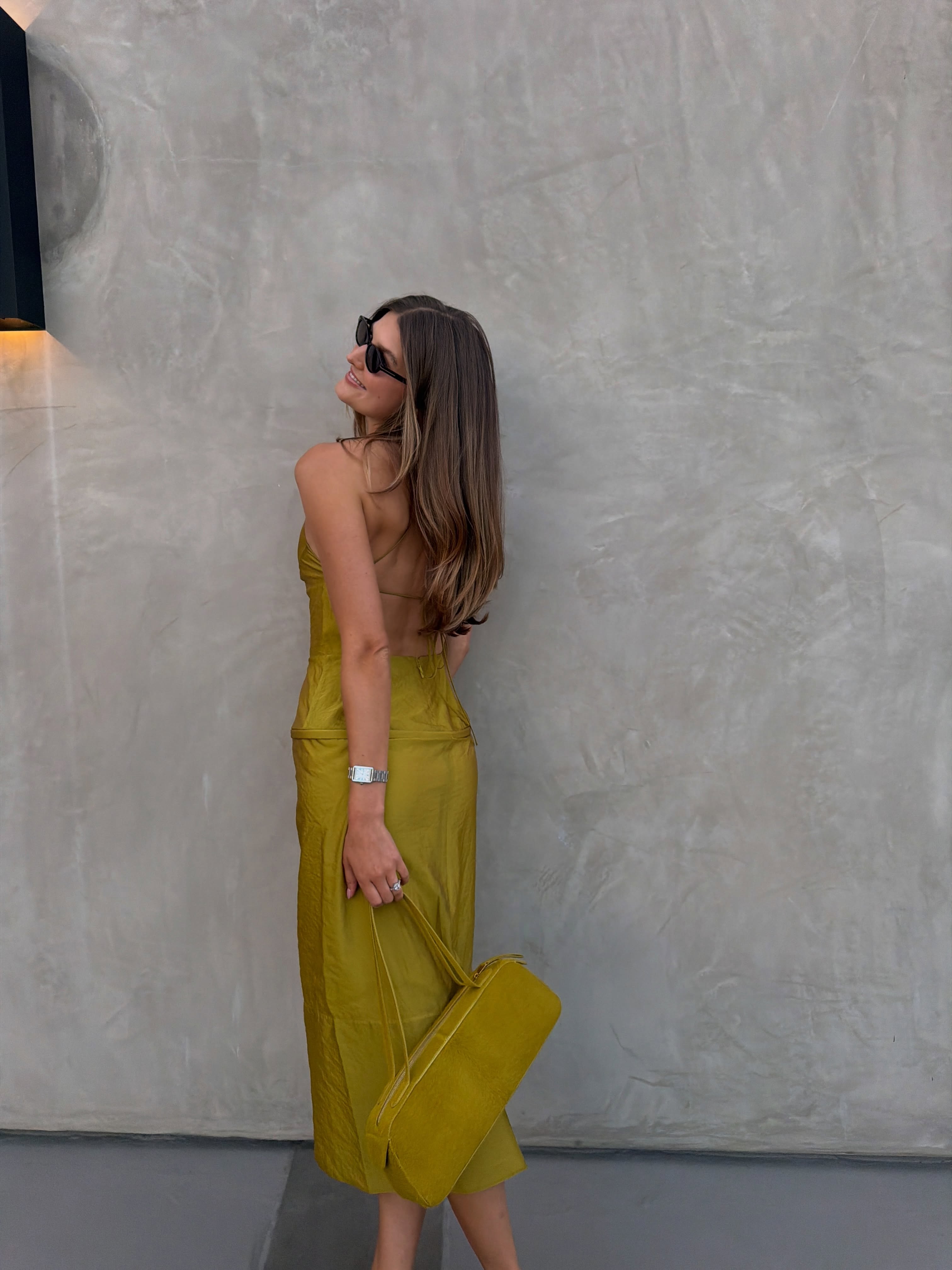 Sara Walker in a tennis ball yellow Tibi set and Khaite bag.