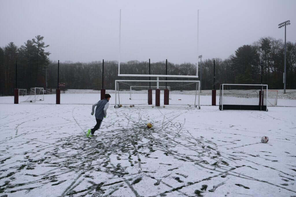 Brandon Velez trains on a snowy field at Concord-Carlisle High School in January 2024. Photo by Janel Apuna