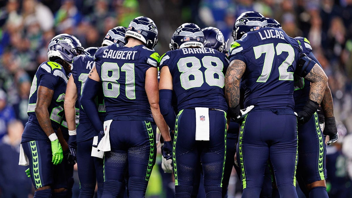Seahawks players huddle during a game