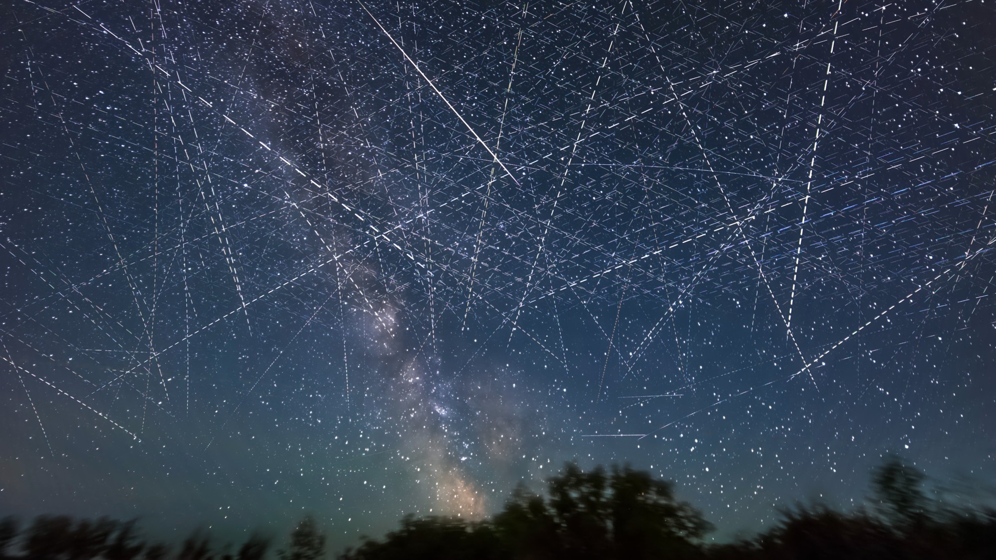 crisscrossed lines of light in the starry night sky