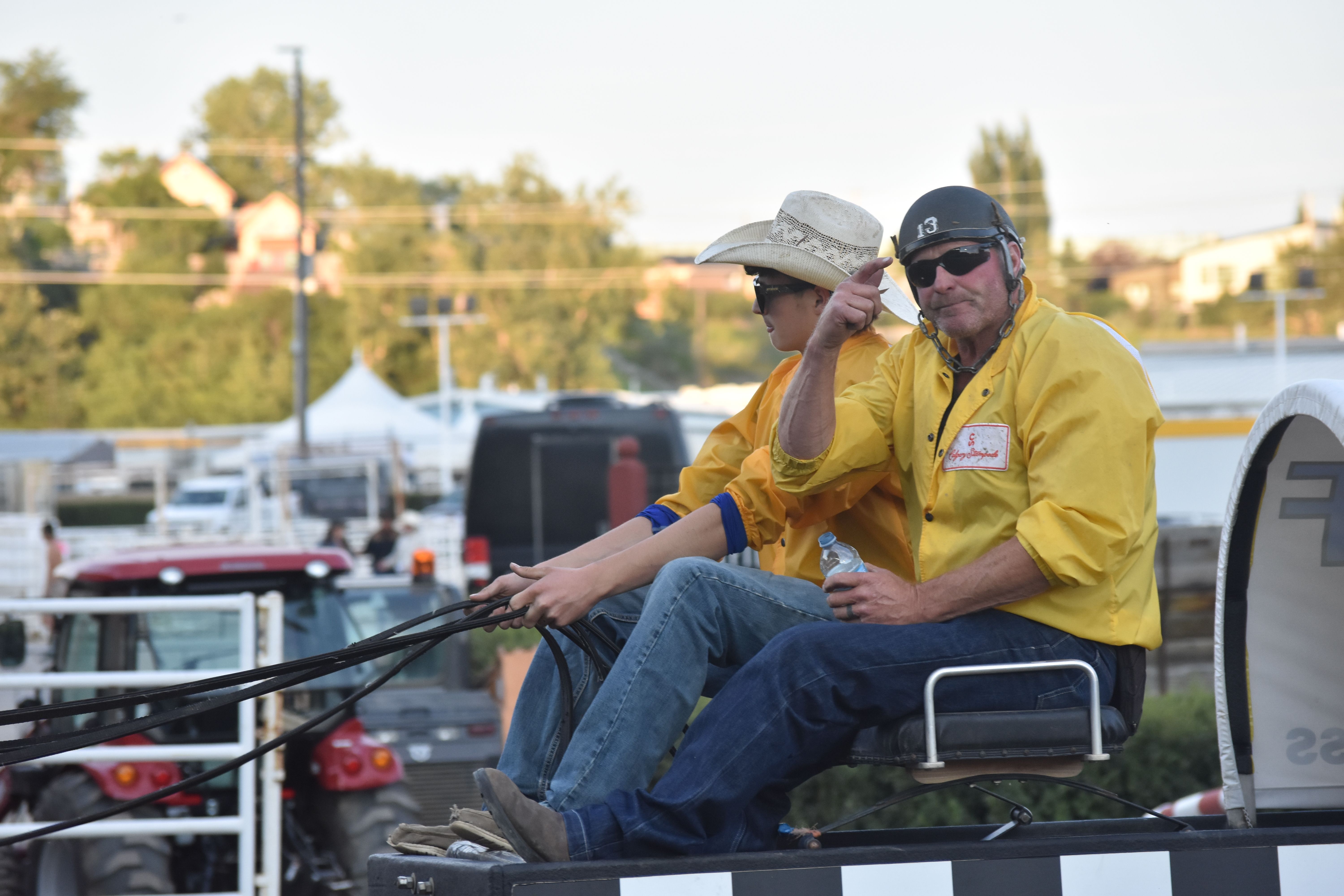 High River's Jason Glass, right, rides with his son Bodie before the championship final of the Calgary Stampede Rangeland Derby on Sunday. Glass, a fourth-generation chuckwagon driver, finished third overall. OkotoksOnline/Jayden Steidl