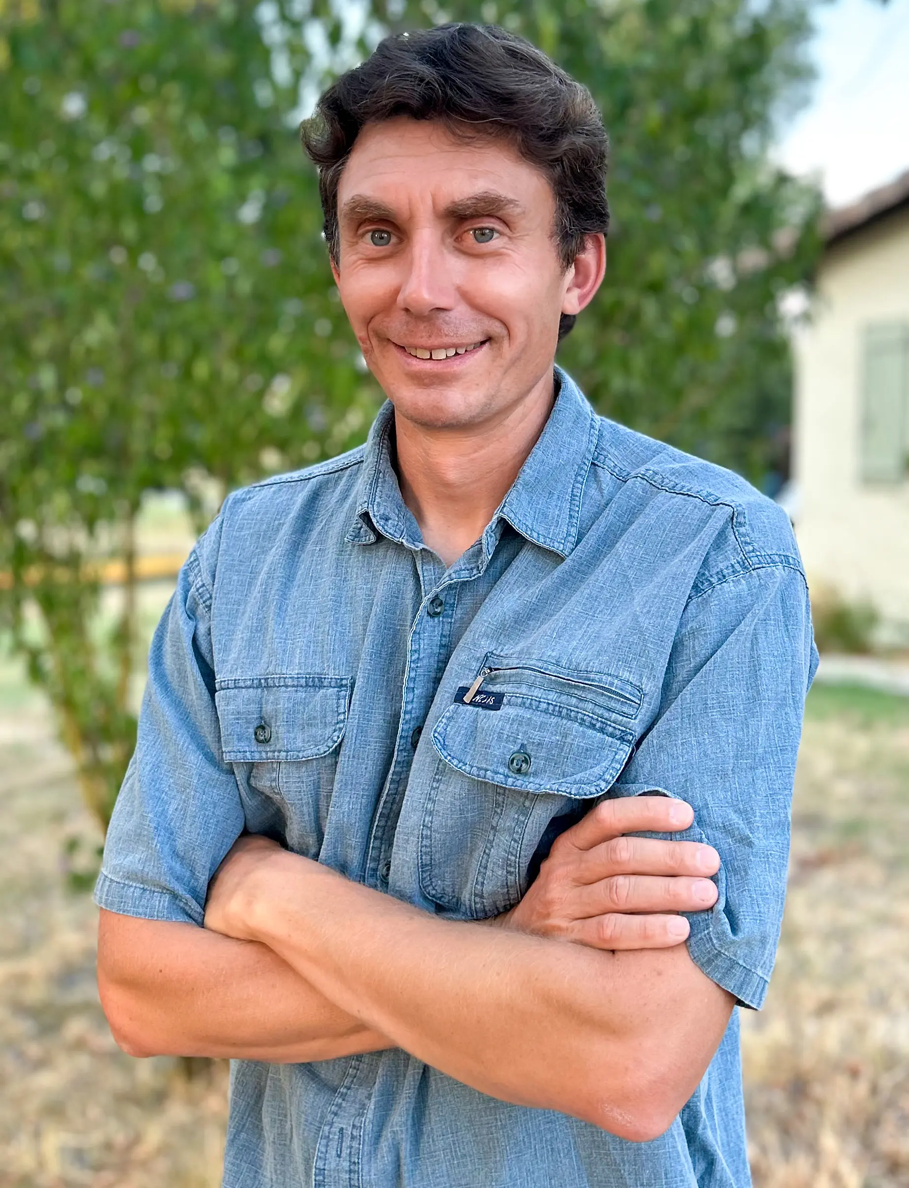 Portrait of a man in a collared shirt outdoors