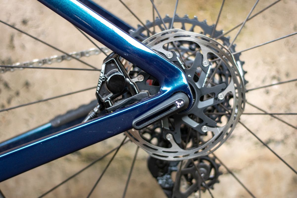 An Argon 18 Anti Matter gravel bike leaning against a concrete wall.