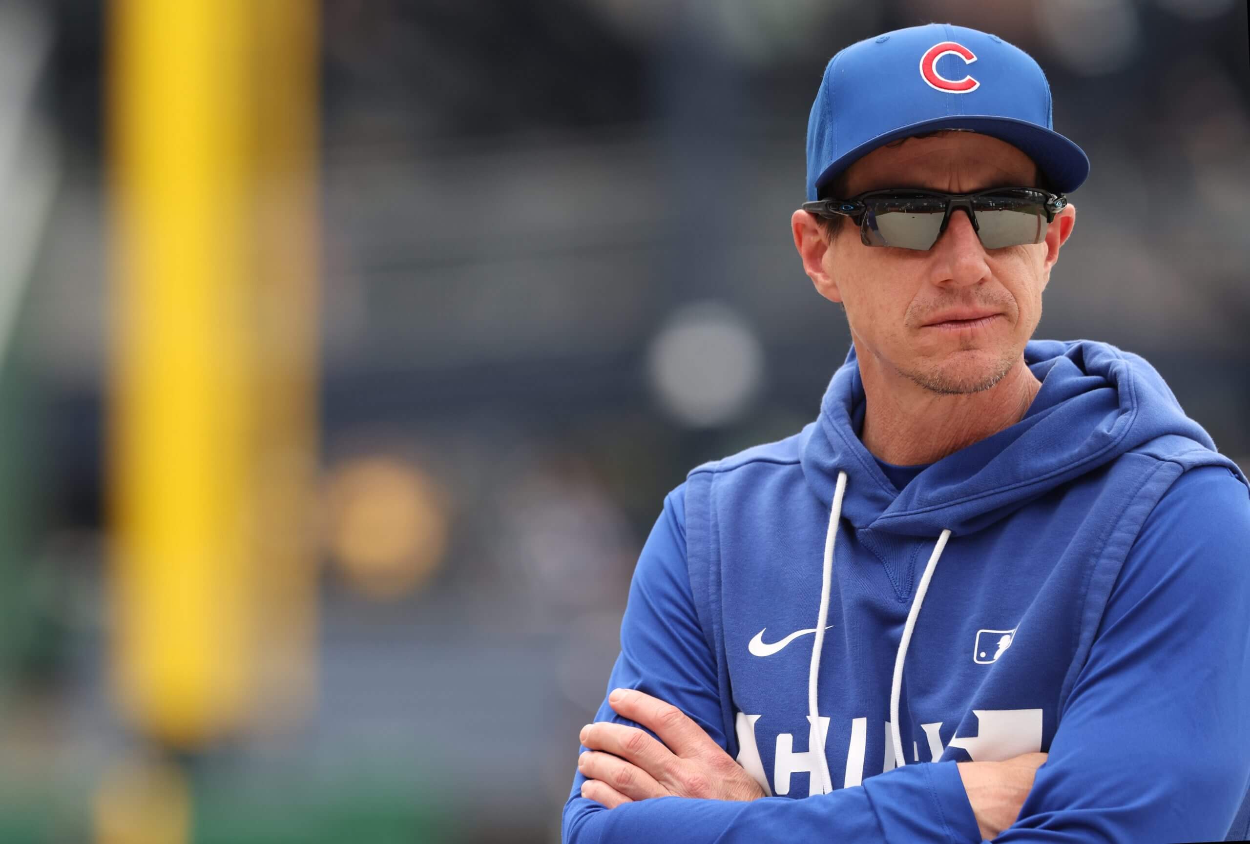 Craig Counsell watches batting practice before a game.