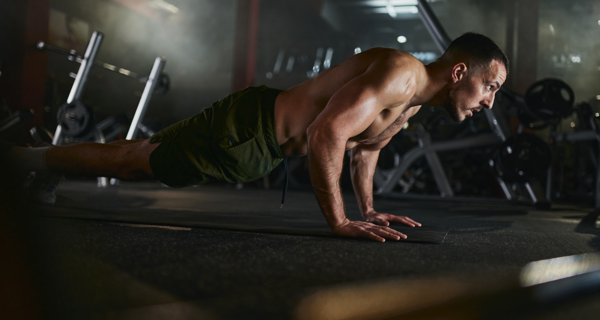 A man performing a push up in the gym
