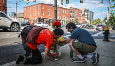 Two people brought flowers on July 9 to the intersection of Tremont and Parker streets in Boston, where Louisa Gag, 36, was fatally struck by a truck while cycling. Gag was a bike share and transportation planner for the city of Boston and a cycling advocate.