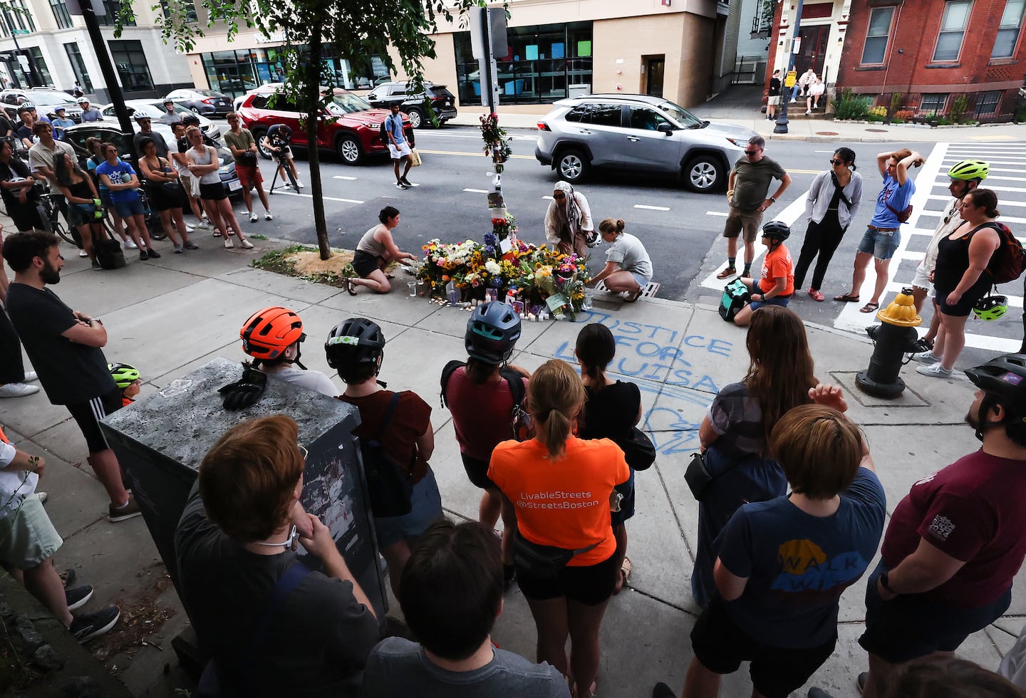 People gathered for a memorial vigil where Boston bike activist Louisa Gag was killed.
