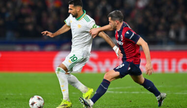 BOLOGNA, ITALY - MARCH 12: Zeki Celik of AS Roma is challenged by Remo Freuler of Bologna during the UEFA Europa League 2025/26 Round of 16 First Leg match between Bologna FC 1909 and AS Roma at Stadio Renato Dall