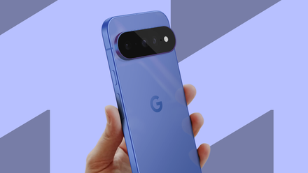 A hand holding a blue Google Pixel 11 showing its rear camera bar against a light blue geometric background.