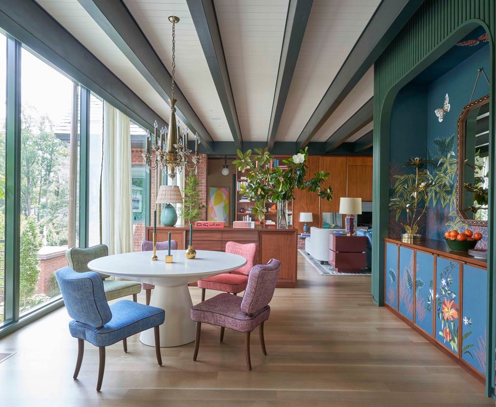 modern dining area with mural niche and ornate lighting