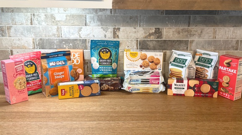Multiple bags and boxes of various store-bought gluten-free cookies