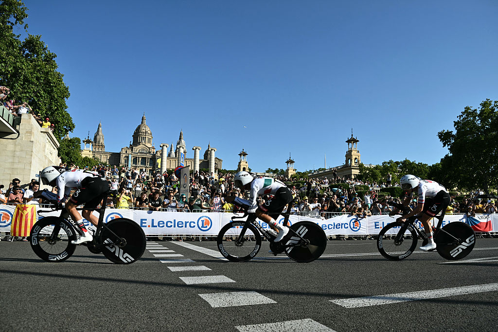 UAE Team Emirates - XRG's Slovenian rider Tadej Pogacar (R) cycles with his team next to the Palau nacional ('National Palace') on the hill of Montjuic during the 1st stage of the 113th edition of the Tour de France cycling race, a 19,6 km team time trial stage in and around Barcelona in northeastern Spain, on July 4, 2026. (Photo by Jeff PACHOUD / AFP)
