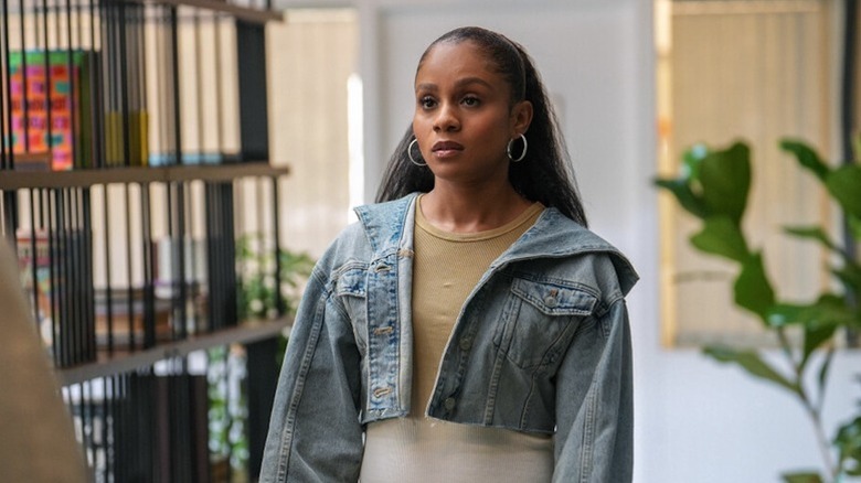 Simone Hicks (Geffri Maya) stands expectantly outside in All American: Homecoming