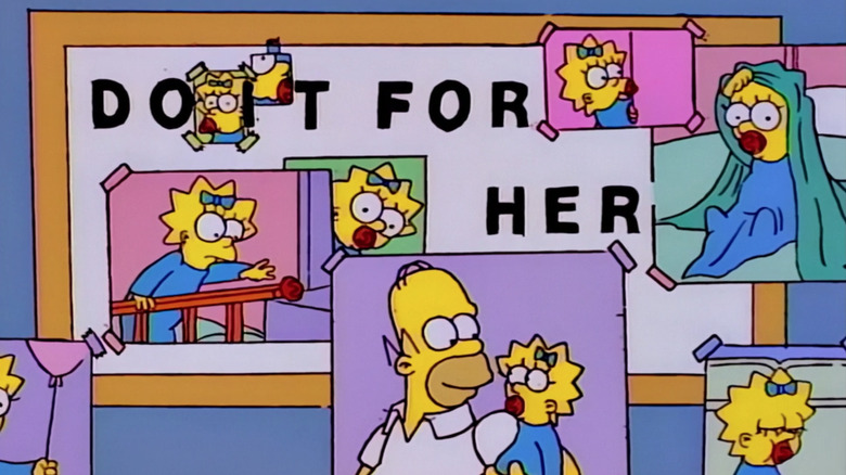 Homer holds Maggie in a photograph in 