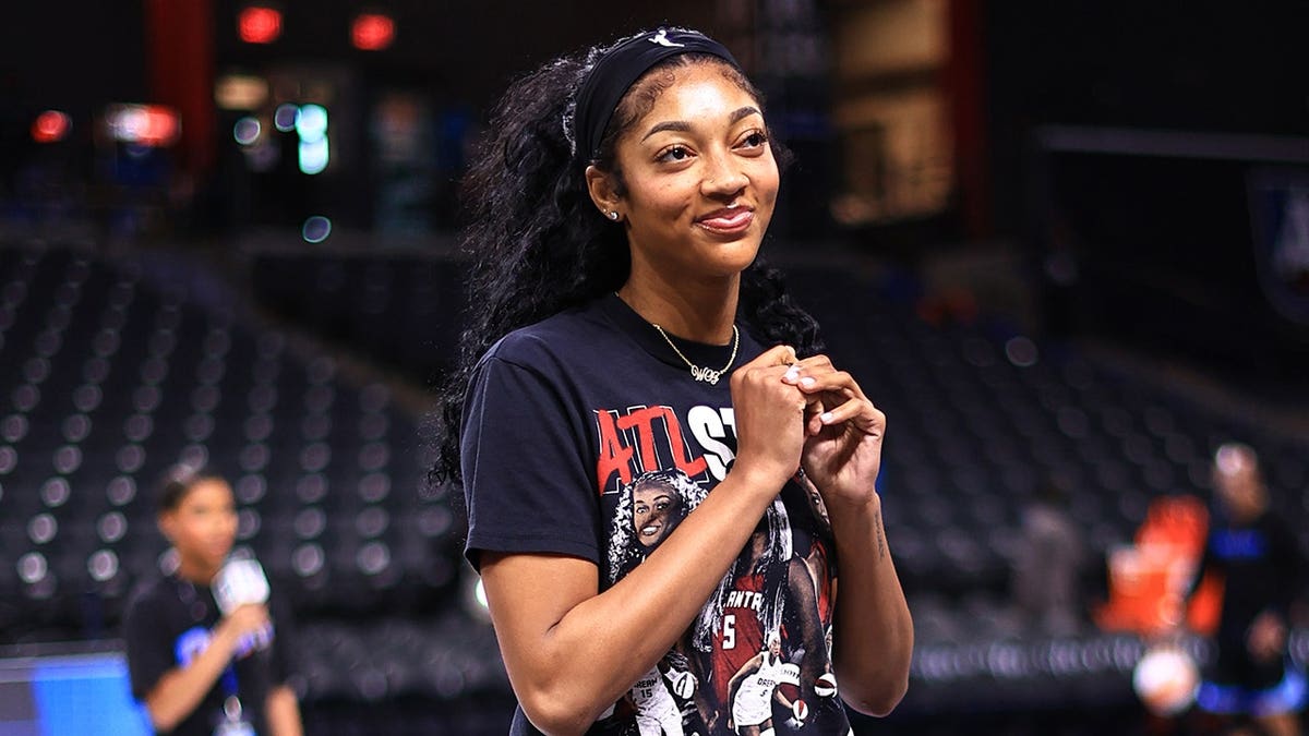 Angel Reese smiles before a game in Atlanta.
