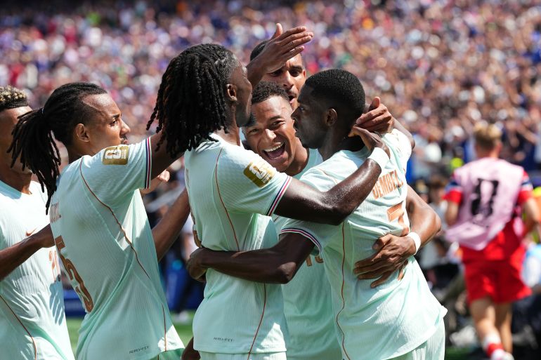 France's Ousmane Dembele, right, celebrates with Kylian Mbappe and other teammates after scoring his side's third goal during the World Cup Group I soccer match between Norway and France in Foxborough, Mass., near Boston, Friday, June 26, 2026. (AP Photo/Martin Meissner)