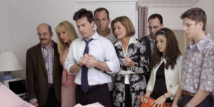 The main cast of Arrested Development in Season 1 looking over a hospital bed.