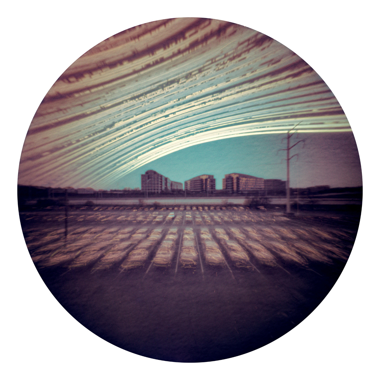 Solargraph 182 Days © Ksawery Wrobel (USA). Solargraphy is a photographic technique that uses a homemade pinhole camera and photosensitive paper to create extremely long exposures. Depending on how long the camera remains in place, the final image records the Sun’s path across the sky from dawn to dusk, as well as its gradual shift from north to south (or vice versa) between the solstices. Each bright streak represents a day of sunlight. If a streak is missing, it means the Sun was hidden by clouds. This method makes it possible to expose the paper for weeks, months, or even years. Ksawery Wrobel uses small round aluminium jars, as they are easy to install in urban spaces. Taken with a homemade pinhole camera, Kodak Kodabrome II RC paper, 23.5 mm f/130, 182 days total exposure from 17 July 2022–15 January 2023