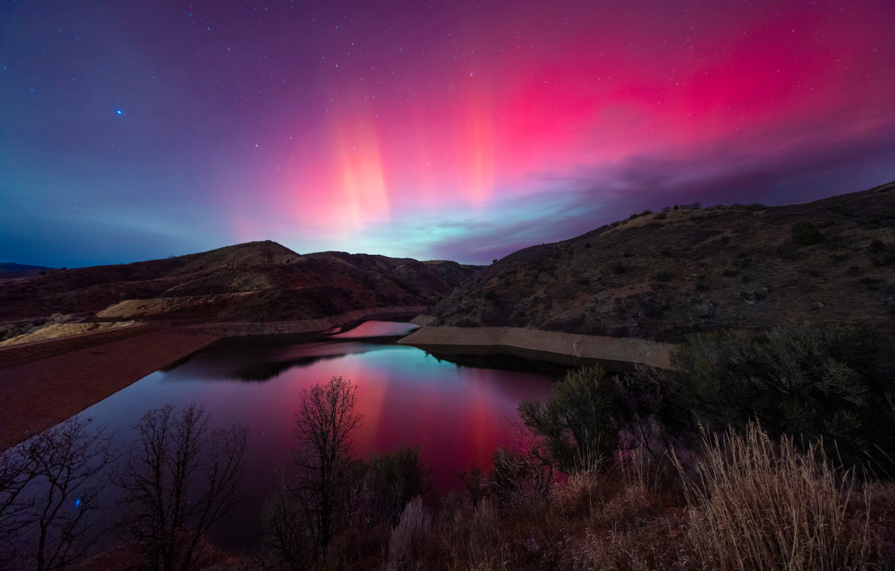 Aurorae. Aurora Over Causey Reservoir © Samuel Morse (USA). This stunning aurora shot is a straightforward single-frame image with no compositing or other alterations. The colour balance was pushed slightly towards blue to enhance vibrancy and create colors that complemented the red in the sky. Taken with a Sony ILCE-7M4 camera, tripod, Laowa AF 10 mm f/2.8 Zero-D lens, 10 mm f/2.8, ISO 1600, 30-second exposure Location: Weber County, Utah, USA, 11 November 2025