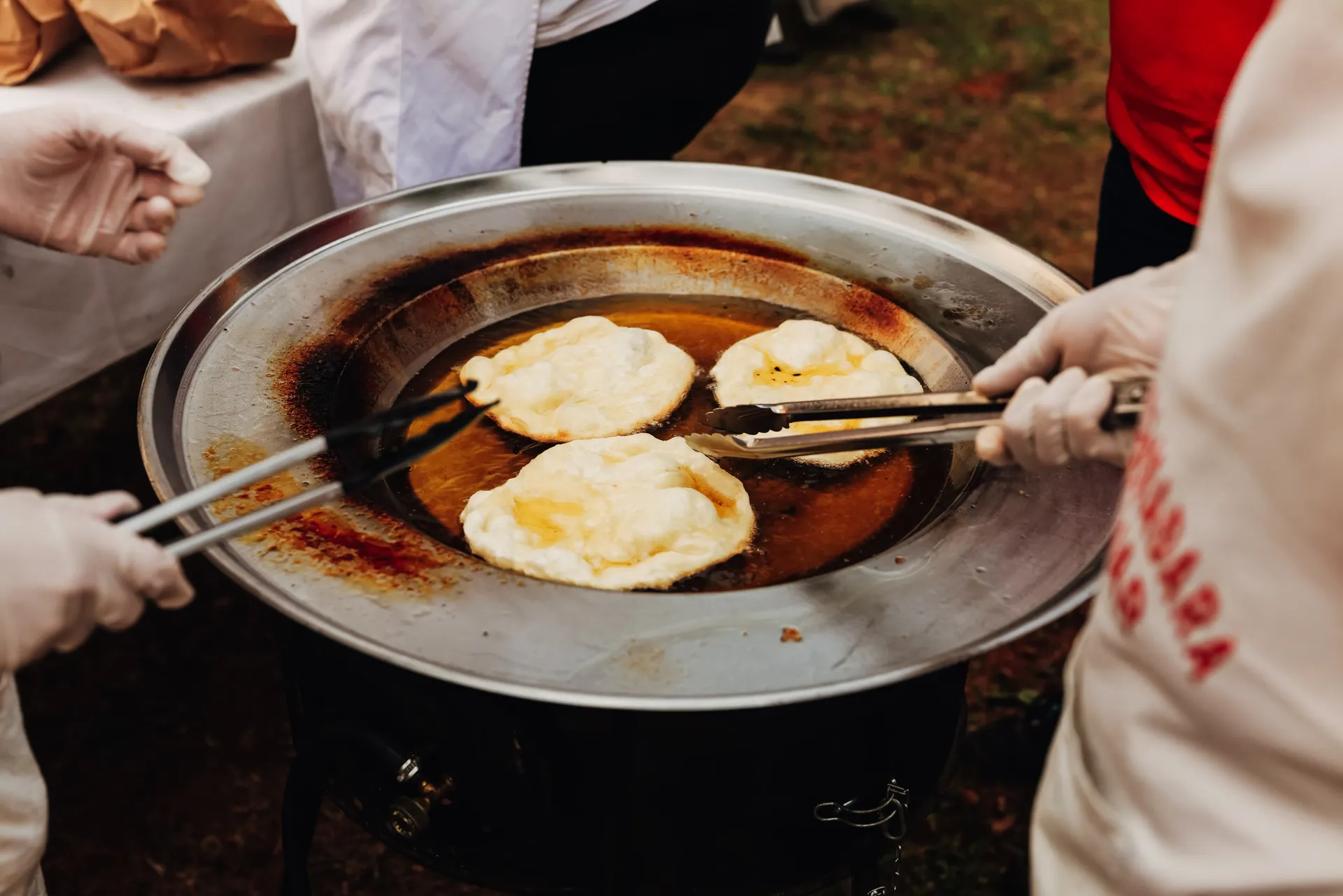 Traditional Hungarian chimney cakes being freshly prepared at a Budapest food market.