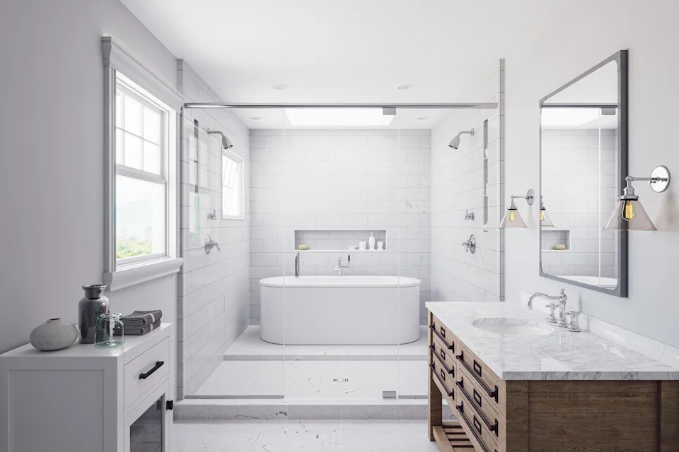 Modern bathroom featuring a freestanding tub, glass shower enclosure, wooden vanity with marble top, and large window for natural light