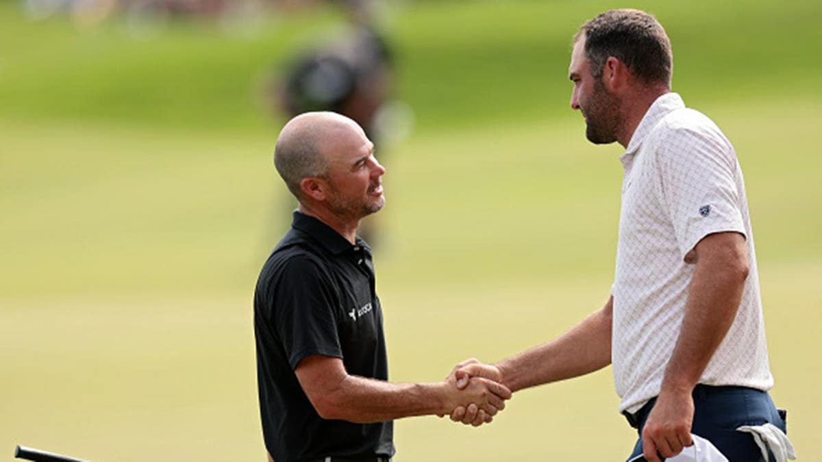 Brian Harman and Scottie Scheffler shake hands on the 18th green.