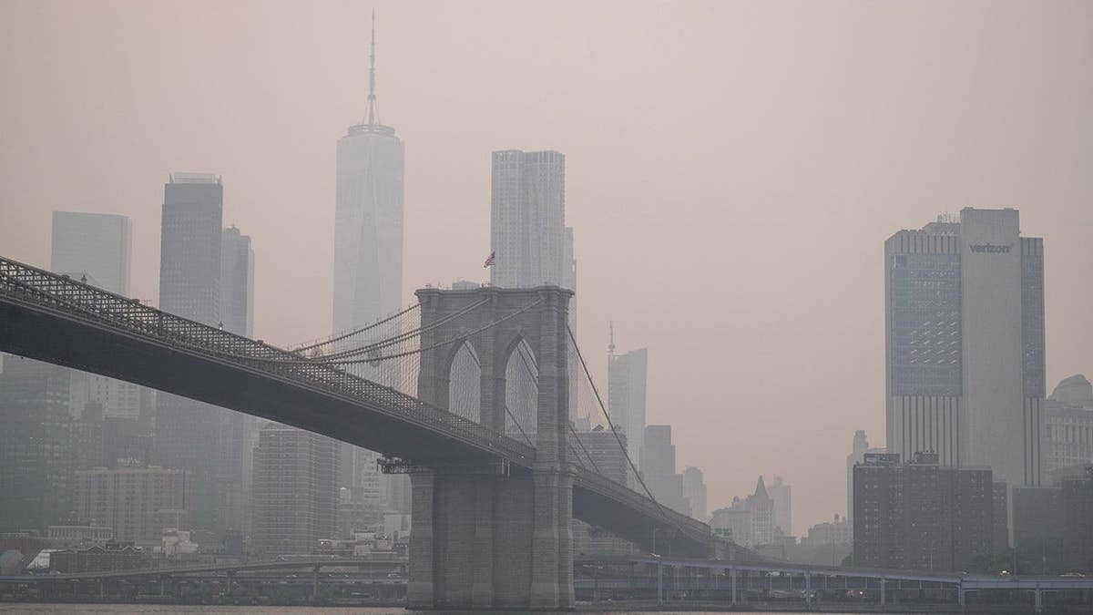Smoke shrouds the Manhattan skyline over Brooklyn.