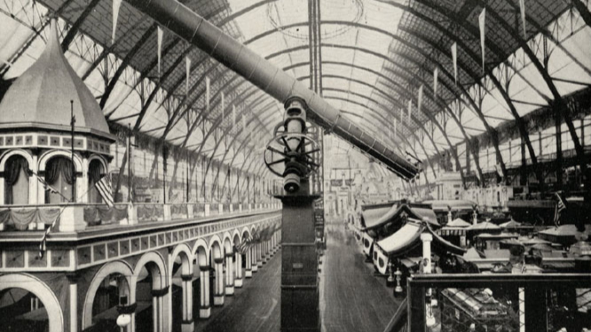 A black and white photo of a telescope on a very tall pedestal at a fair.