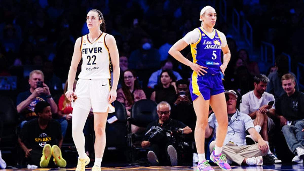 A photo showing Caitlin Clark of the Indiana Fever and Dearica Hamby of the Los Angeles Sparks on the court at Crypto.com Arena.