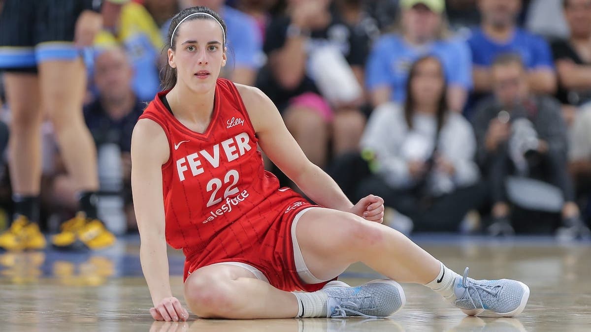 Caitlin Clark No. 22 of the Indiana Fever sits on the court after being fouled during the second half of a WNBA game against the Chicago Sky at Wintrust Arena in Chicago, Ill., on Aug. 30, 2024.